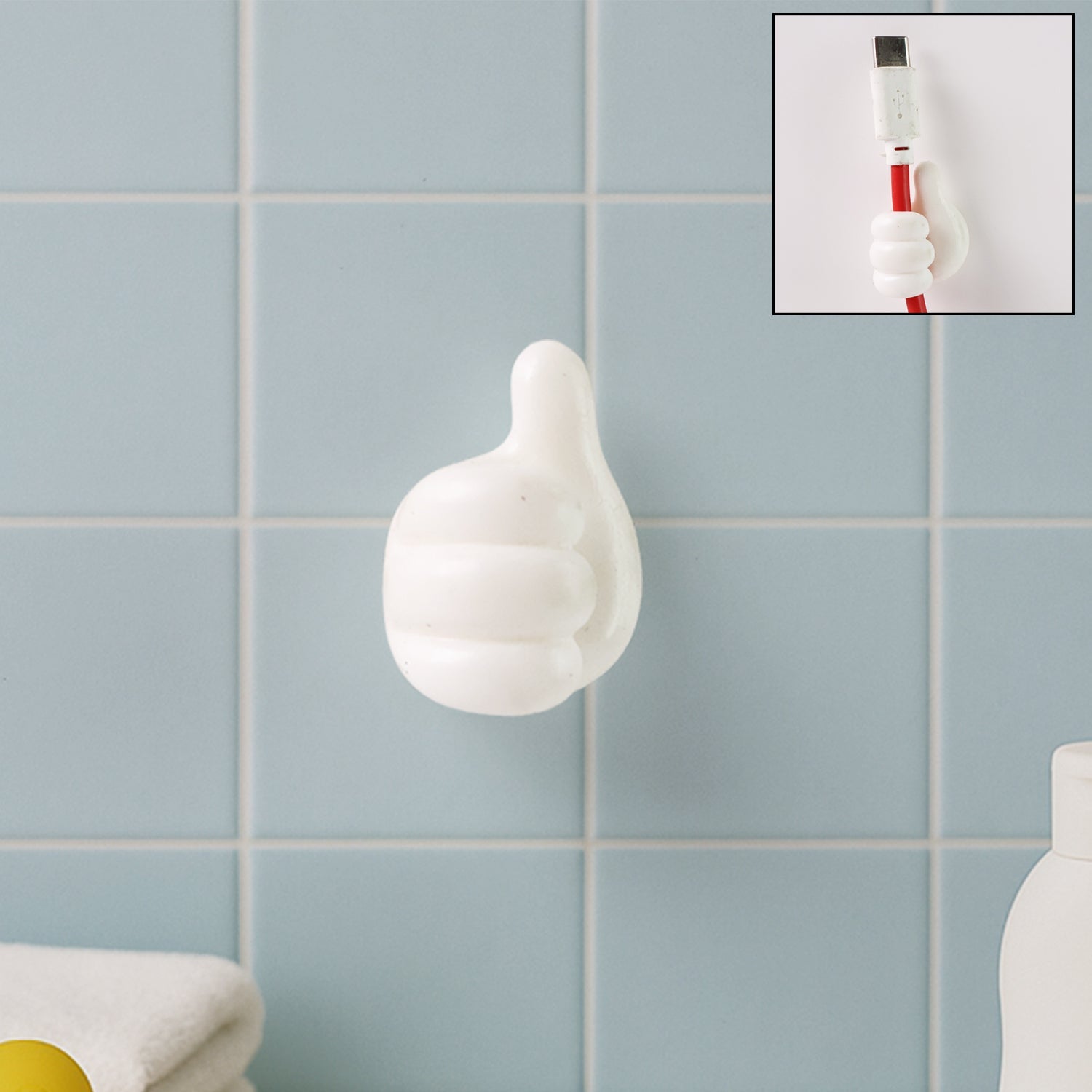 White hand-shaped wall clip with thumb grip