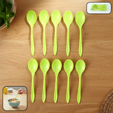 Set of 10 fancy plastic spoons laid out on white background