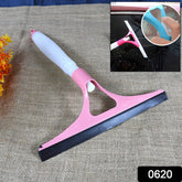 Person using the cleaning brush with spray bottle on a glass surface