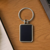 Premium rectangular black and silver metal keychain on white background