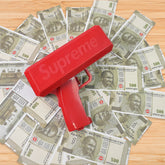Money gun shooting a cascade of cash bills into the air