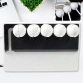 5-slot adhesive cable holder on a desk organizing wires