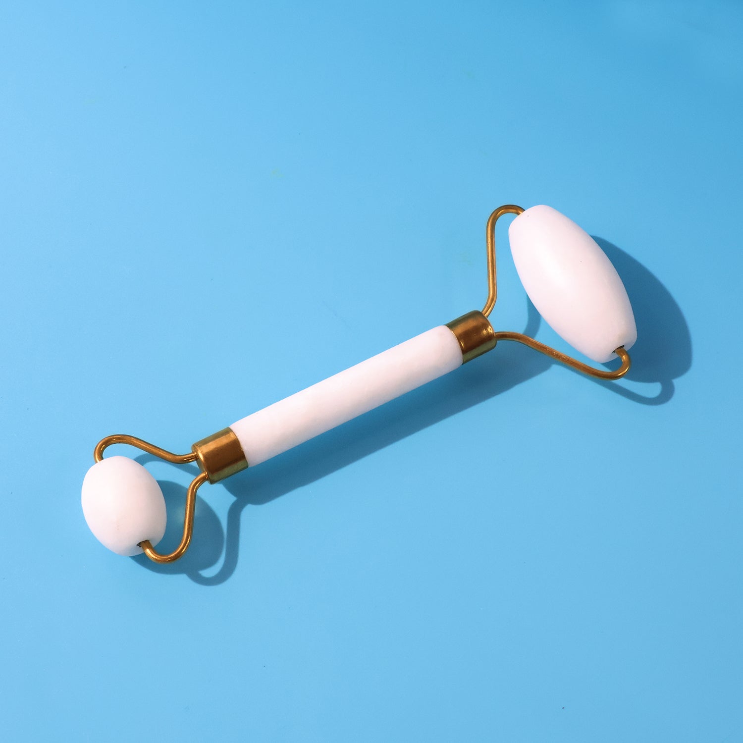Dual-ended face massage roller with cooling stone on metal frame