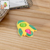 Rocket Fidget Dimple Keychain Toy in yellow, green, and pink colors