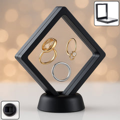 Transparent floating jewellery display box with black frame showing rings and earrings
