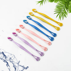 Soft bristle toothbrush and tongue scraper showing bristles and scraper head