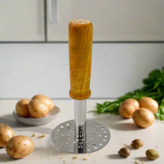 Stainless steel potato masher with wooden handle angled view