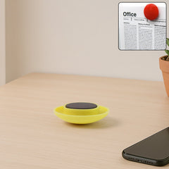 Single yellow circular magnet on a whiteboard