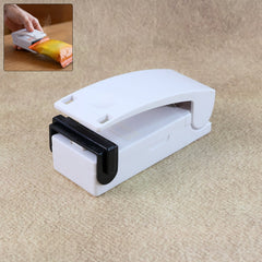 Portable mini heat sealer machine sealing a plastic bag