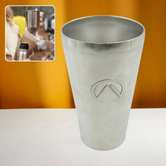 Travel mug in hand outdoors