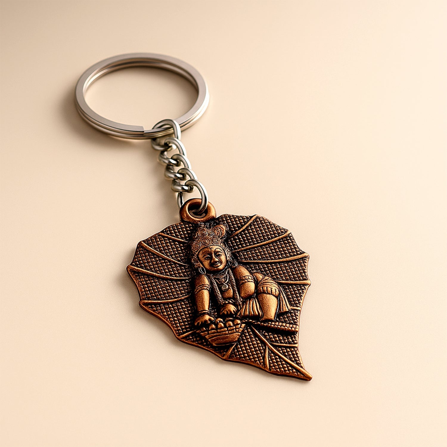Antique bronze Bal Krishna peepal leaf metal keychain