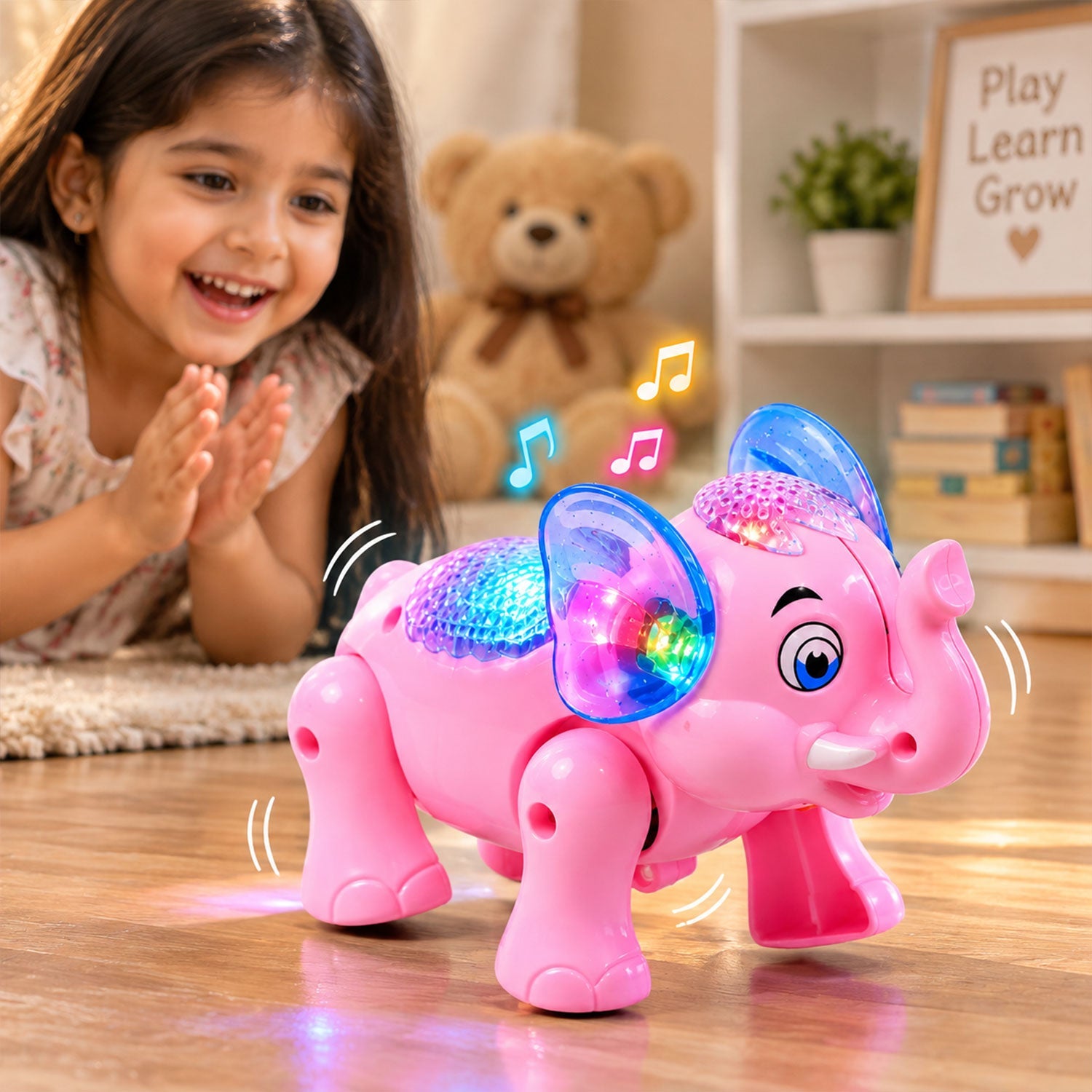 A young girl happily watches a pink elephant toy with flashing lights and musical notes on a wooden floor.