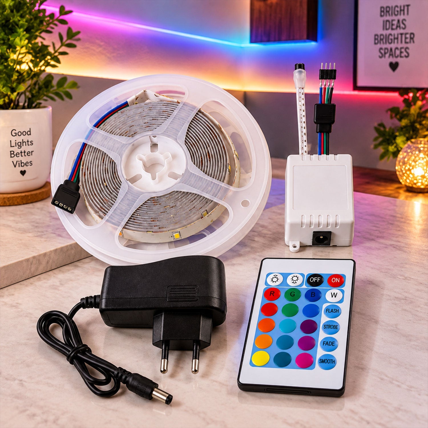 A coiled RGB LED strip light, white controller, power adapter, and remote control on a wooden surface.