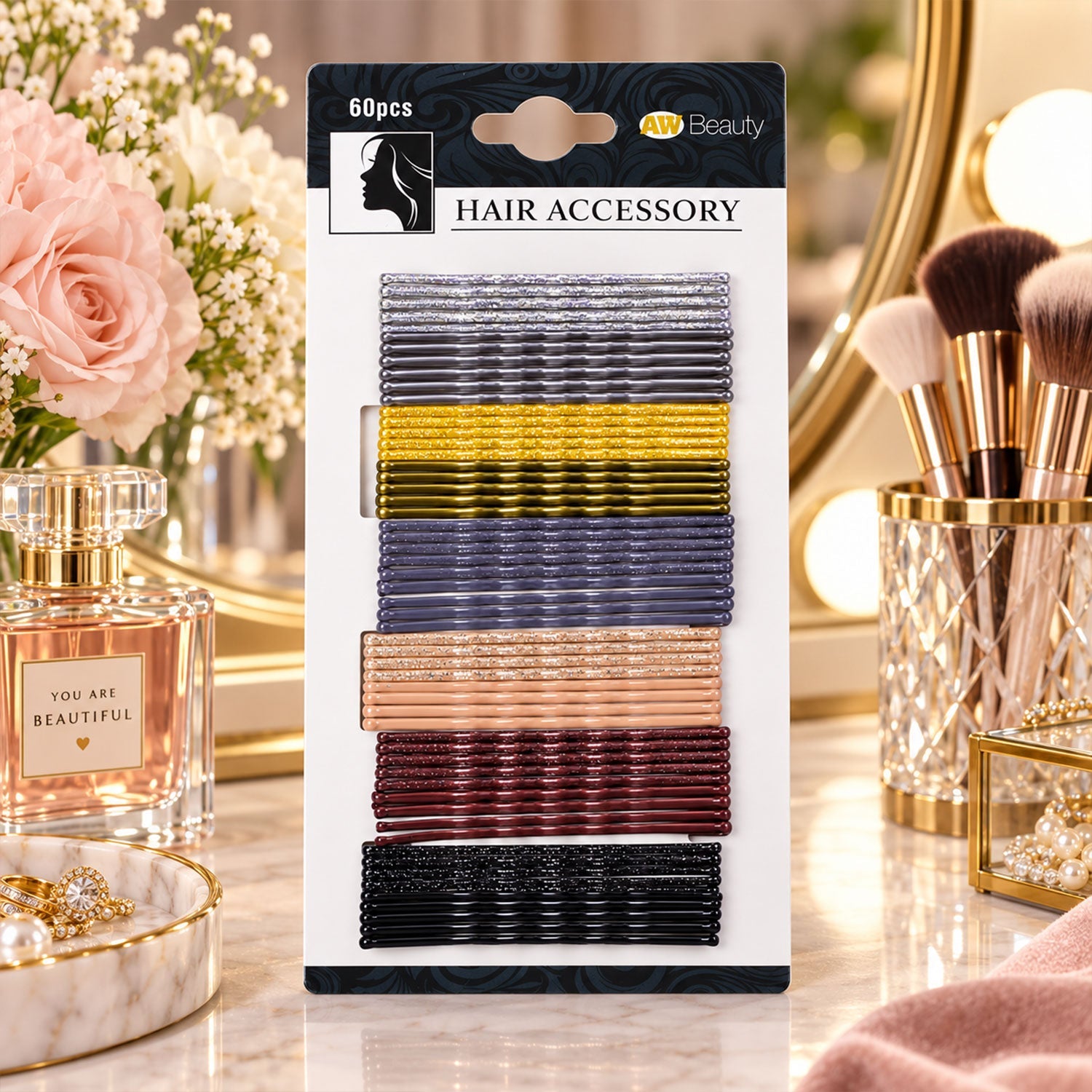 A package of 60 glittery hairpins in seven colors sits on a vanity with flowers and perfume.