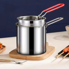 Crispy fries cooked in deep frying pot with basket