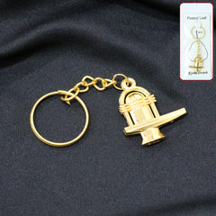 Golden Shivling metal keychain on white background