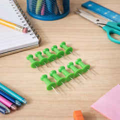 Green plastic push pins thumb tacks close-up