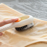 Multifunctional scrubbing brush with liquid dispenser on white background