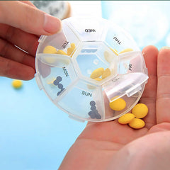 Close-up of pill box compartments with bold and Braille labels