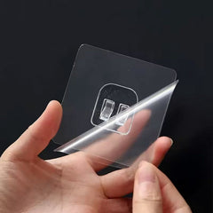 Self adhesive wall hook mounted on glass surface