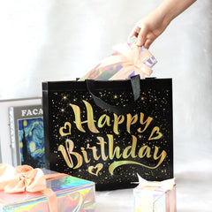 Close-up of golden star design on black gift bag