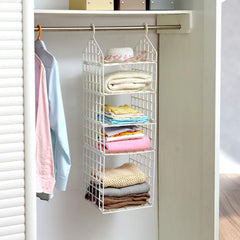 Clothes hanging on different tiers of storage rack