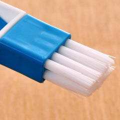 Mini dustpan attached to cleaning brush handle