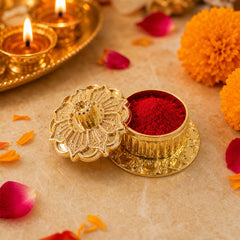 Golden kankavati placed on pooja thali with religious items