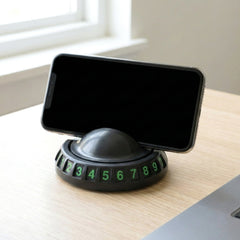 Close-up of the dashboard mobile holder showing the anti-slip base and parking number display.