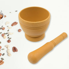 Mortar and pestle crushing fresh herbs