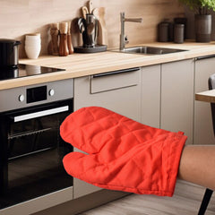 Oven mitt being worn to handle hot cookware