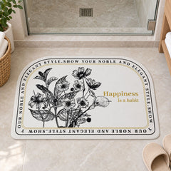 A half-round white mat with a black floral design and a golden quote, next to slippers in a contemporary bathroom.