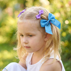 Set of three ribbon bow hair clips with smooth fabric texture