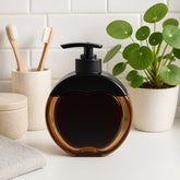 Apple-shaped refillable liquid soap dispenser with amber body and black pump