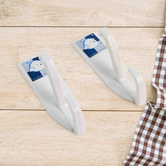 Close-up of self-adhesive hook holding towels in bathroom