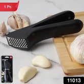 Close-up of manual garlic crusher tool