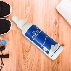 Deodorizer spray bottle beside multiple pairs of shoes