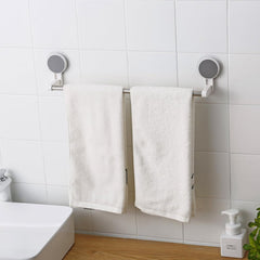 Self-adhesive towel rod mounted in a bathroom