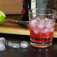 Round silicone ice cubes in a glass with a refreshing drink