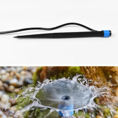 Multiple water flow drippers irrigating a garden bed
