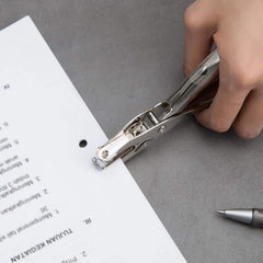 Handheld metal hole puncher punching paper