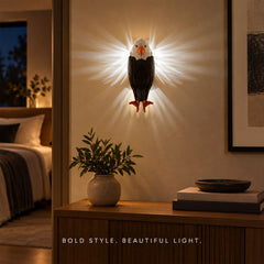 A geometric eagle wall light with bright light radiating from its sides, mounted on a wall in a modern living space.