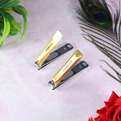 Hand holding stainless steel folding nail clippers for trimming nails