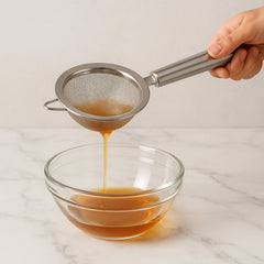 Steel kitchen strainer in use