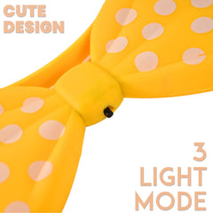 Close-up of LED glowing bow hairband with polka dots