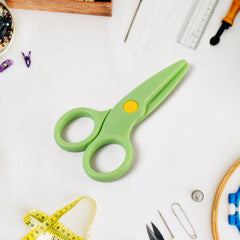 Plastic safety scissors for toddlers on a craft table