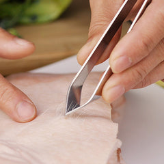 Fish bone remover tweezer on kitchen surface