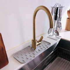Faucet splash guard keeping bathroom countertop dry and clean