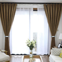 Magnetic curtain tieback twisted to shorten length on a window curtain