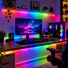 A modern gaming room with colorful RGB LED strip lights illuminating the desk, monitor, and shelves.